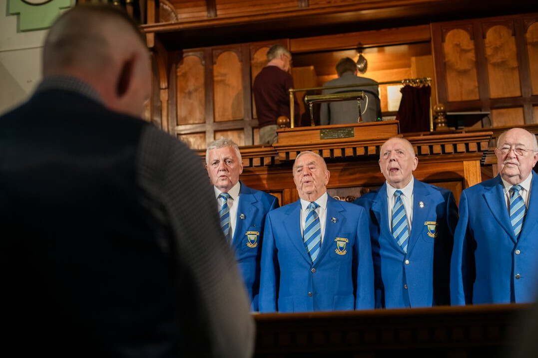 Group of seniors singing together in a community choir