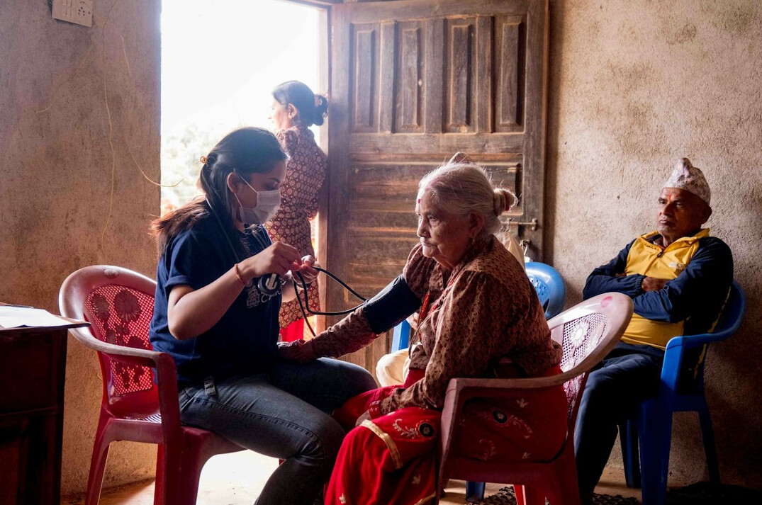 Young volunteer helping an elderly woman