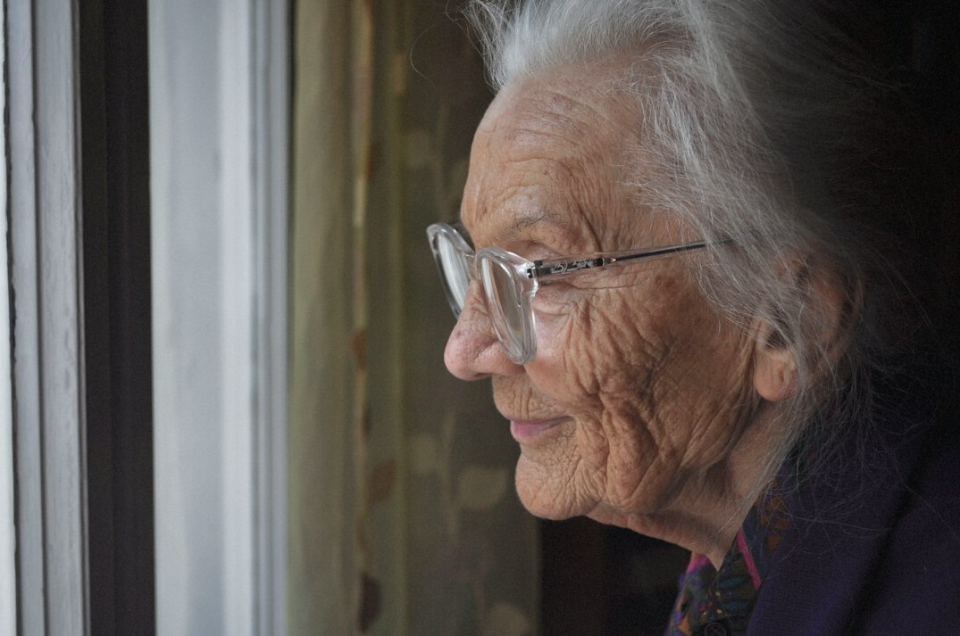 Portrait of a smiling elderly Swiss woman wearing glasses